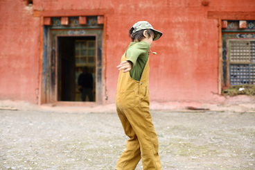 boy dancing by Dzongsar monastery Ganzer Deger