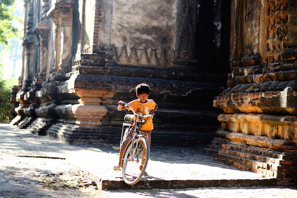 boy on bike by temples of Bagan, Burma